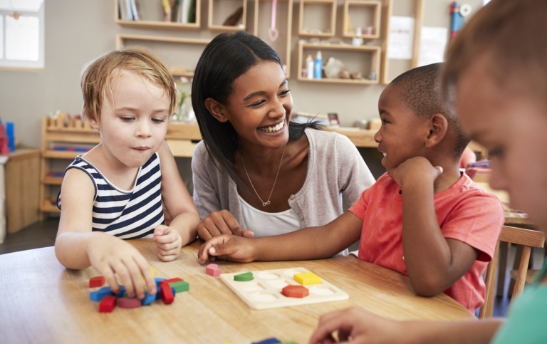 21326051-teacher-and-pupils-using-wooden-shapes-in-montessori-school_Gabby_Baldrocco.jpg